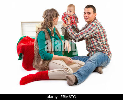 Baby boy in old box with his parents on white background Stock Photo