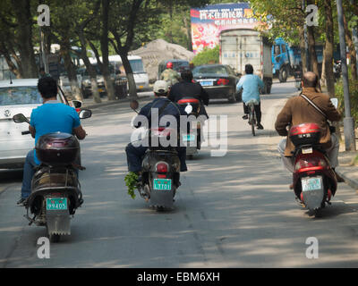 People riding mopeds in China, Asia Stock Photo