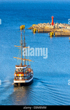 Oil painting style picture of historic sailing ship leaving port. Stock Photo