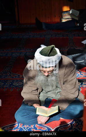 Sufi reads Quran in the mosque inside the residence of Shaikh Nazim Al-Haqqani, leader of the Naqshbandi-Haqqani Sufi Order, Lef Stock Photo