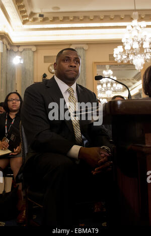 NFL executive and former player Troy Vincent testifies during a US Senate Commerce Committee hearing about domestic violence in professional sports December 2, 2014 in Washington, DC. Vincent told the committee that abuse was a 'way of life' in his home when he was growing up because his mother was beaten. Stock Photo