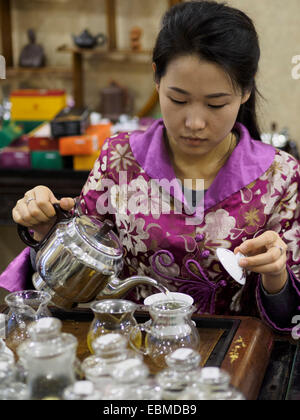 Young woman pouring tea during a traditional chinese tea ceremony Stock Photo