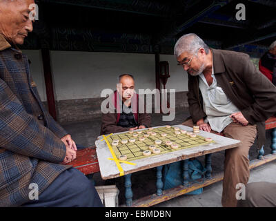 Old men playing a chinese chess board game Xiangqi Stock Photo