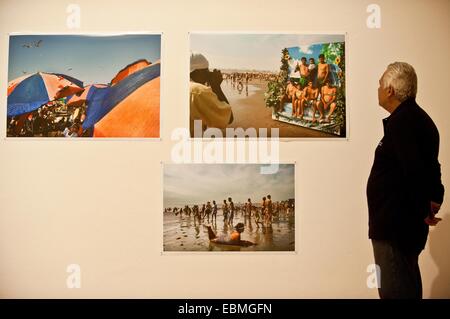 Santiago, Chile. 2nd Dec, 2014. A person watches the exhibition 'From the Red River to the Green Sea', of the Peruvian photographer Adrian Portugal, in the Museum of the Contemporary Art (MAC, for its acronym in Spanish), in Santiago, capital of Chile, on Dec. 2, 2014. © Jorge Villegas/Xinhua/Alamy Live News Stock Photo