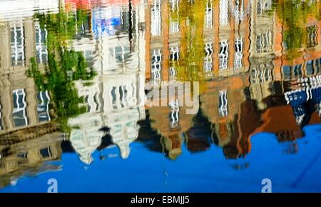 Nottingham city centre buildings reflected in the fountain water feature.England UK Stock Photo