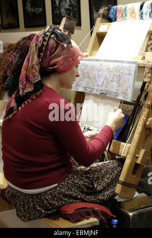 Woman working in a carpet factory, Cappadocia, Central Anatolia, Turkey Stock Photo