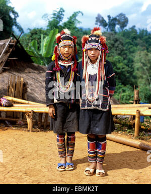 Two Akha girls in a mountain village in traditional costume and headdress, Chiang Rai Province, Northern Thailand, Thailand Stock Photo