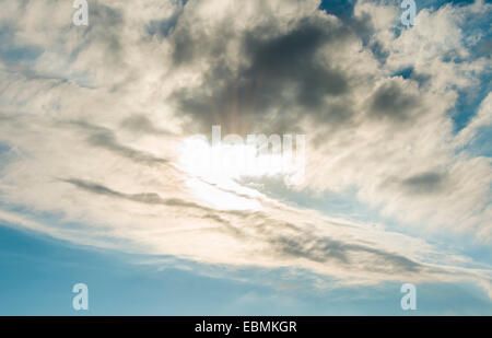 Sun shining through clouds Stock Photo