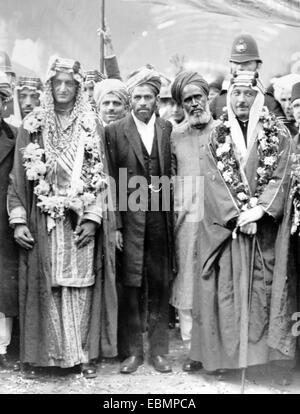 Crown Prince of Saudi Arabia, Faisal bin Adbulaziz al Saud (to left), later Monarch or King of Saudi Arabia, on Royal Saudi visit to London to visit the Fazi Mosque or London Mosque in 1935. Prince Faisal became Foreign Minister of Saudi Arabia in 1930, under the reign of his father, Ibn Saud, first monarch of Saudi Arabia. The Fazl Mosque or London Mosque was the first purpose-built mosque in London, inaugurated in October 1926. Stock Photo