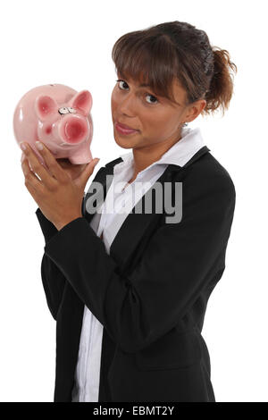 Businesswoman holding piggy-bank Stock Photo