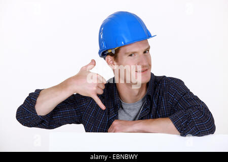 Manual worker making a phone shape Stock Photo