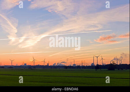 field landscape with wind power stations in morning light, Arcelor Mittal steelwork in background, Germany, Bremen Stock Photo