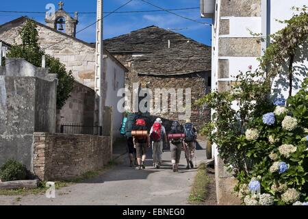 pilgrims on the way in Gonzar, Spain, Galicia, Lugo, Gonzar Stock Photo