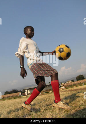 boy playing football in the city's old football stadium, Burundi, Bujumbura mairie, Bujumbura Stock Photo
