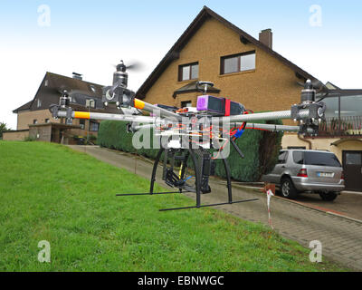 civile drone flying on the edge of a residential area, Germany Stock Photo