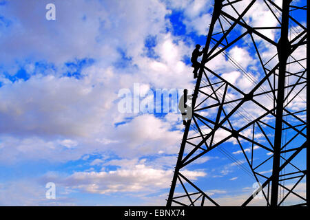 electricians climbing up on power pole, Germany Stock Photo