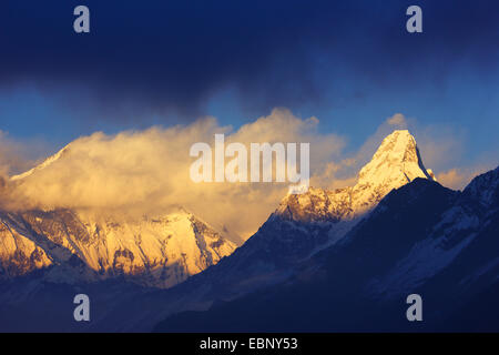 Lhotse (in clouds), Ama Dablam at sunset near Kongde Hotel, Nepal, Khumbu Himal Stock Photo