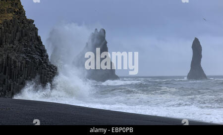 rough sea at the black beach of Vik, rock needle Reynisdrangar in background, Iceland Stock Photo