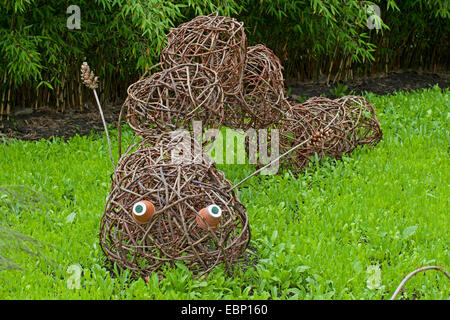 caterpillar made of willow twigs in a garden Stock Photo
