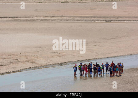 tidal flat hiking at low tide on sandy tideland, France, Brittany Stock Photo