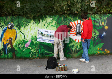 graffiti artists painting a wall Stock Photo