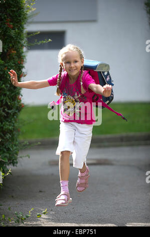 happy school girl on her way to school, Germany Stock Photo