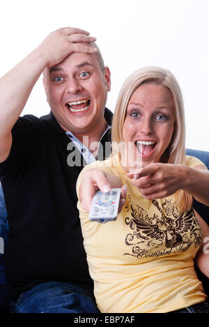 couple with remote control Stock Photo