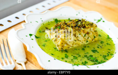 Cod in green sauce (Bacalao en salsa verde). Basque cuisine. Stock Photo
