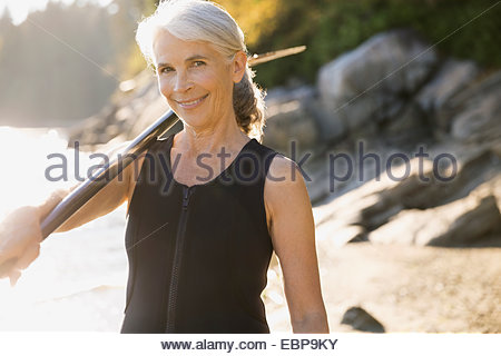 Portrait of senior woman in wetsuit on beach