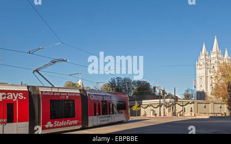 Salt Lake City, Utah - A streetcar of Salt Lake City's TRAX light rail system passes the Mormon Temple. Stock Photo