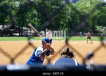 View of a baseball game in New York's Central Park through a chainmail fence Stock Photo