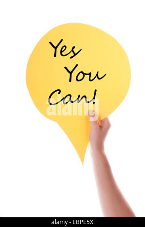 Hand Holding A Yellow Speech Balloon Or Speech Bubble With Yes You Can. Isolated Photo. Stock Photo