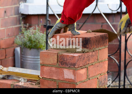 Bricklaying - laying a brick Stock Photo