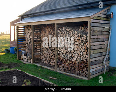 Wood log store on side of house, Widemouth Bay, Bude, Cornwall, UK Stock Photo