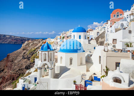 Greek church with three blue domes in the village of Oia, Santorini ...