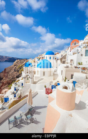 Greek church with three blue domes in the village of Oia, Santorini ...