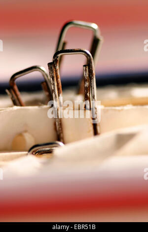 rusty paper clips fixing sheets of paper in a file Stock Photo