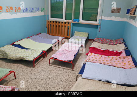 dormitory with small beds for children in the early childhood school Stock Photo