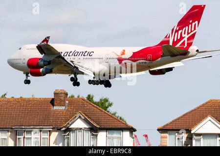 Virgin Atlantic Boeing 747-400 passes over nearby houses on approach to runway 27L at London Heathrow airport. Stock Photo