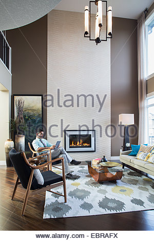 Man using digital tablet in modern living room