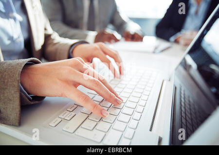 Hands of businesswoman typing on laptop Stock Photo
