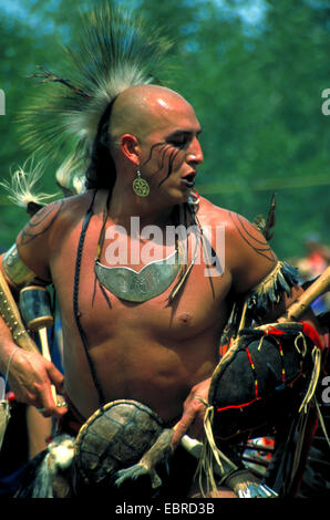 mohican with typical headdress of feathers and face painting at the pow wow in the Kahnawake reservation, Canada, Queebec, Montreal Stock Photo