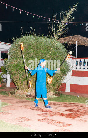 Tibetan fire dancers performing in gardens of a hotel in Goa for tourists. Stock Photo