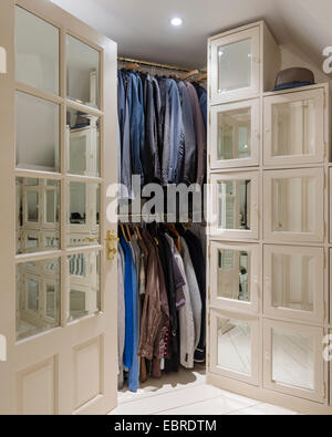 Mens clothing hangs in dressing room of North London home Stock Photo