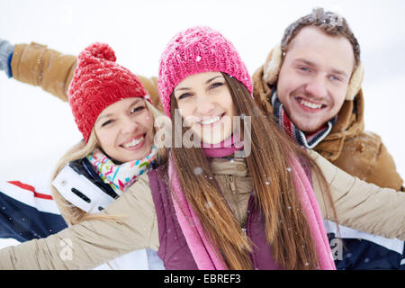 Happy friends walking in winter Stock Photo