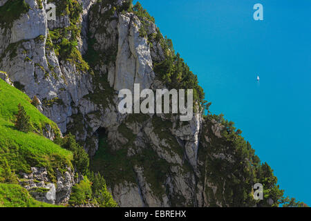 sailing boat on Lake Lucerne and rock wall, Switzerland Stock Photo