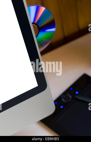 CD ejected from modern computer with white screen for copy space Stock Photo