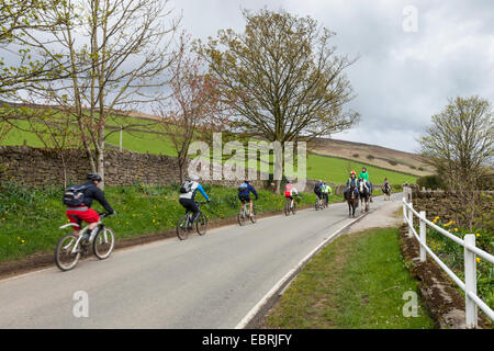 Cycling and horse riding in the Peak District countryside at Nether Booth, Vale of Edale, Derbyshire, England, UK Stock Photo
