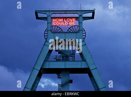 illumination HOW LOVE COULD BE on the pit frame of German mining museum, Germany, North Rhine-Westphalia, Ruhr Area, Bochum Stock Photo