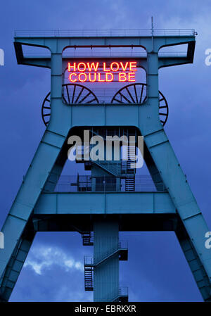 illumination HOW LOVE COULD BE on the pit frame of German mining museum, Germany, North Rhine-Westphalia, Ruhr Area, Bochum Stock Photo